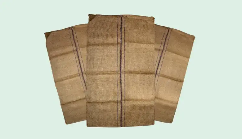 Three brown Standard Binola Jute Bag with dark blue center stripes displayed on a light background.