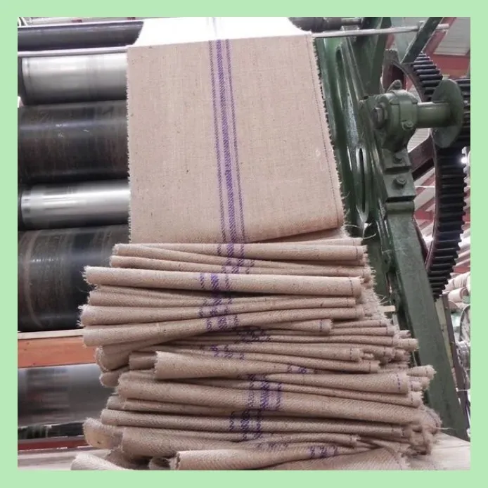Stacked hessian jute cloth with purple center stripe processed in a textile rolling machine