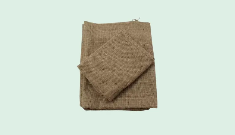 Folded hessian jute fabric sheets ideal for eco-friendly packaging and crafts.
