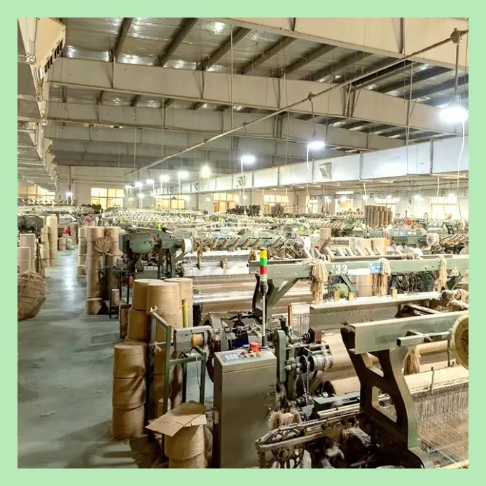 Large-scale jute weaving mill with automated looms and fabric spools