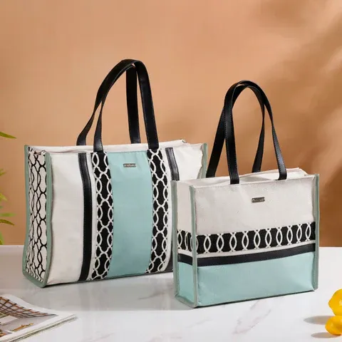 Two stylish jute shopping bags with black handles.